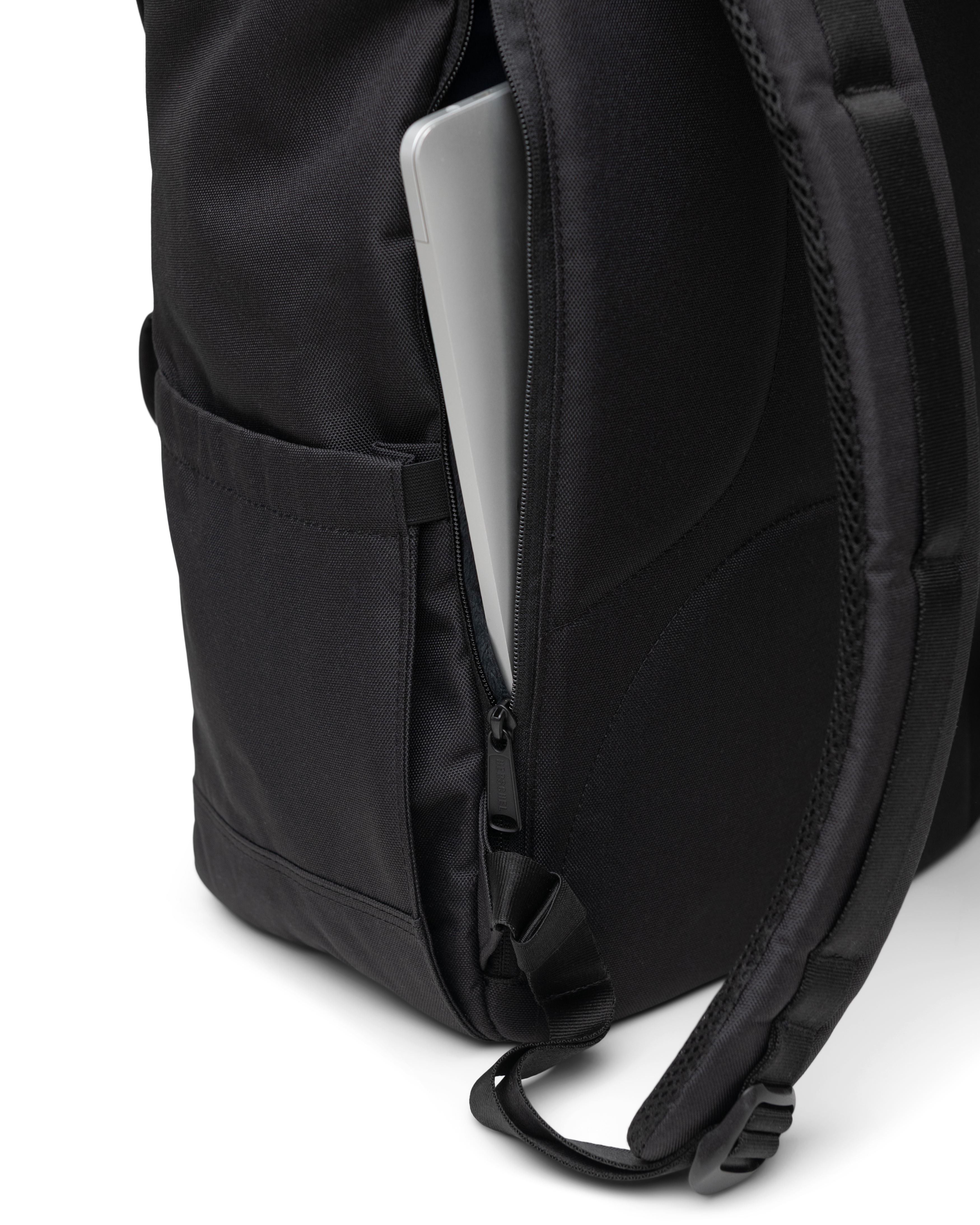 Close-up of the Herschel Little America Backpack detailing its magnetic strap closures and durable fabric construction.