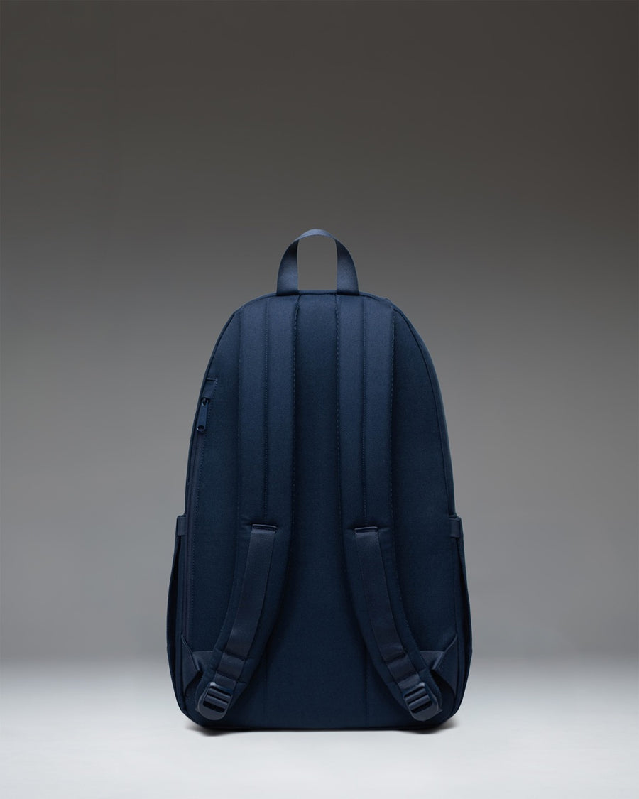 Herschel Seymour Backpack in Navy showing a detailed view of its streamlined design, adjustable shoulder straps, and signature diamond detail.