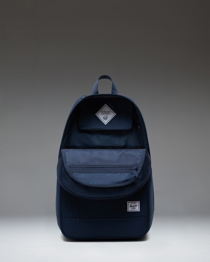 Navy Herschel Supply Co. Seymour Backpack in Navy blue, showcasing its streamlined design, zippered compartments, and signature diamond detail.