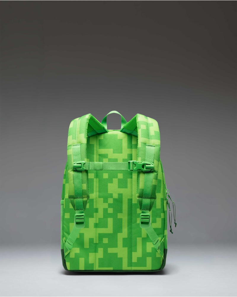 Herschel Supply Co. x Minecraft Heritage Kids Backpack in the pixelated green Creeper pattern featuring a front pocket and brown rubber diamond.