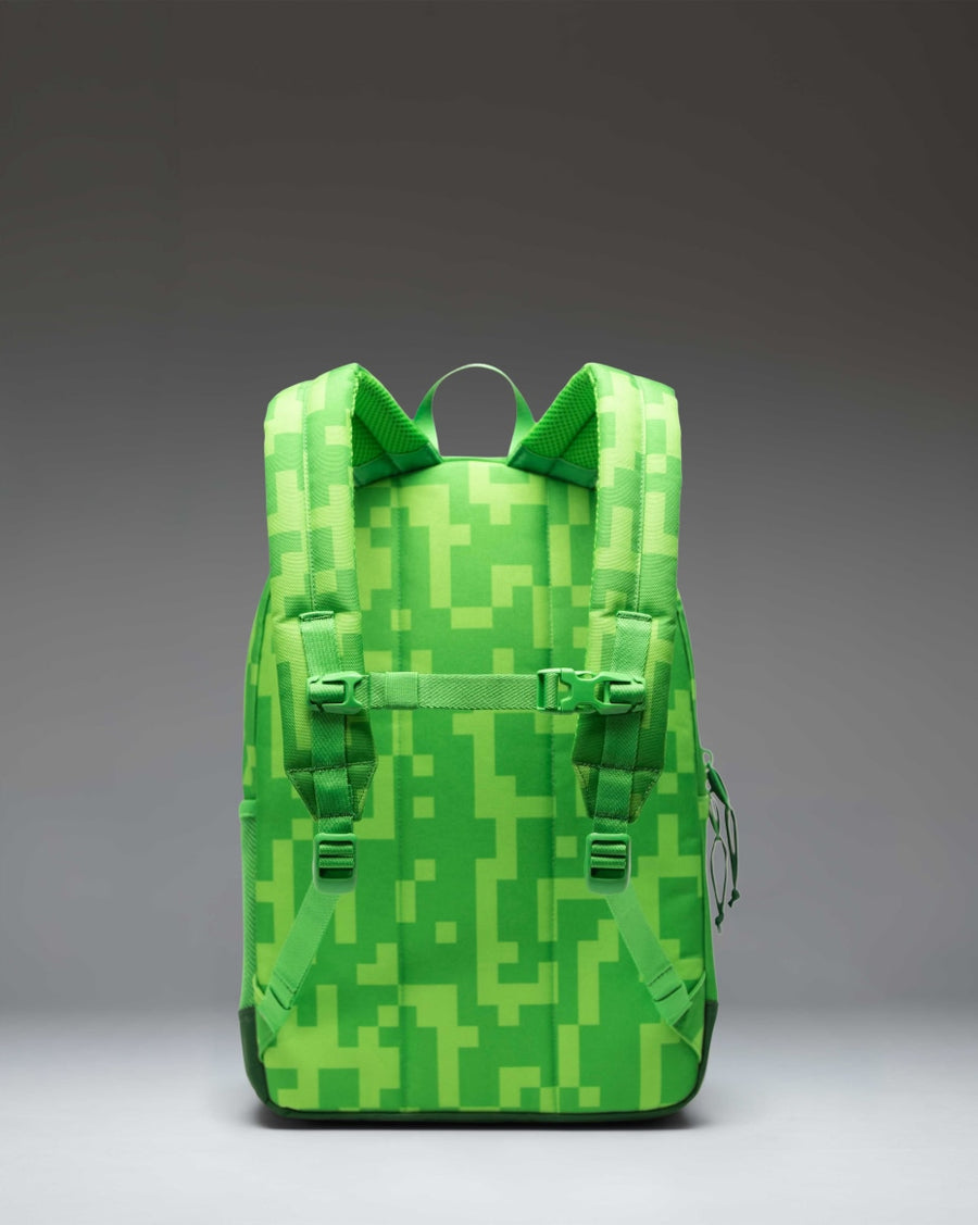Herschel Supply Co. Minecraft Heritage Youth Backpack in Creeper print, featuring a black base with pixelated green Creeper graphics.