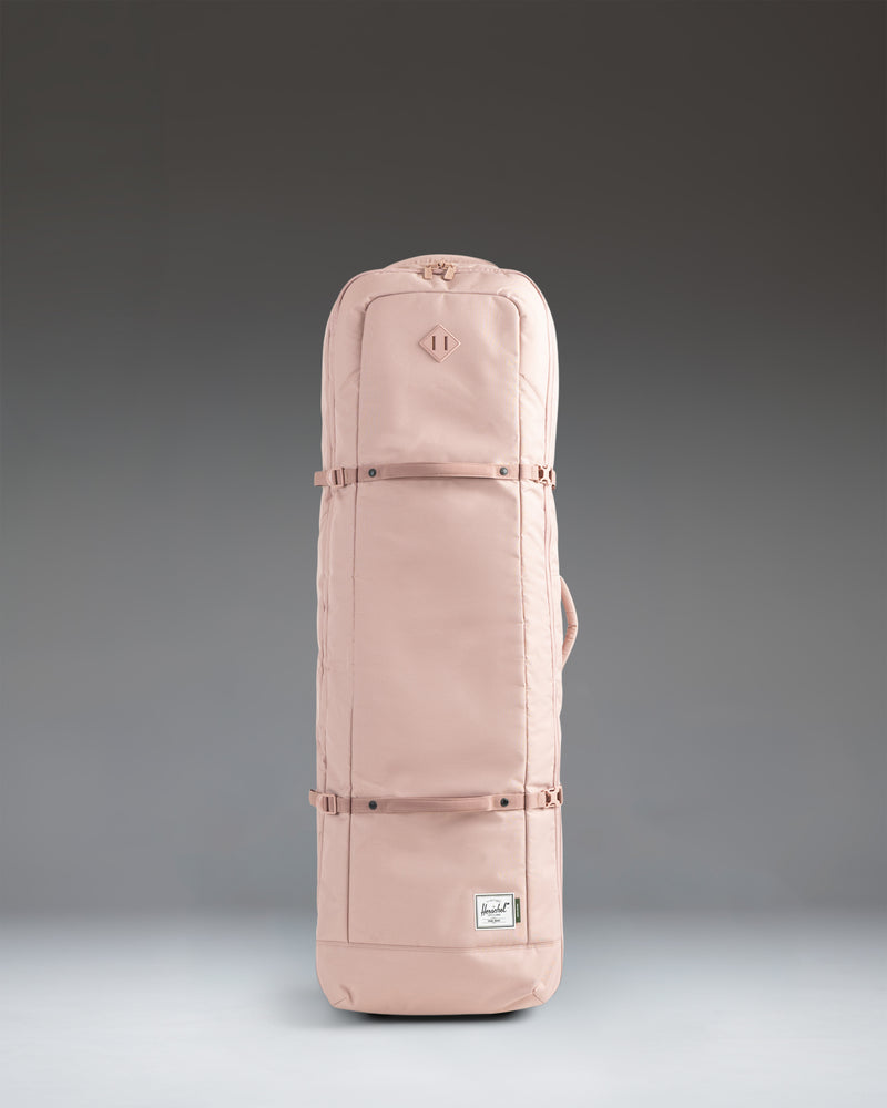 Herschel Heritage Golf Travel Wheelie Bag in Ash Rose pink, showcasing its durable exterior, wheels, and handles.
