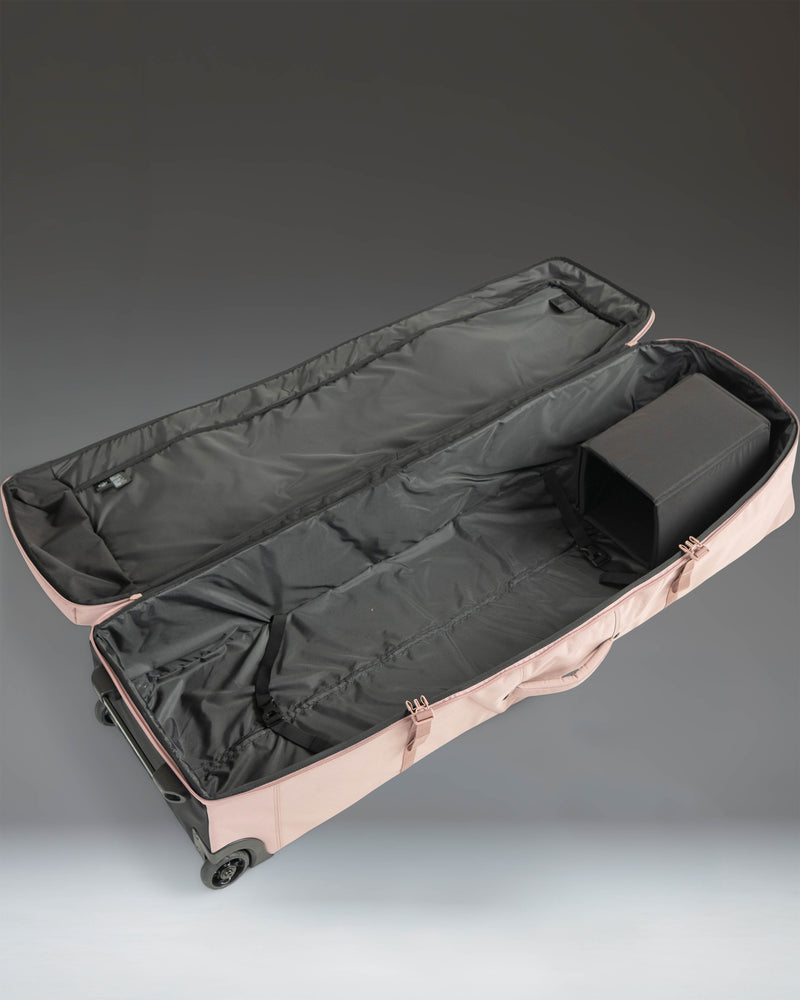 Herschel Heritage Golf Travel Wheelie Bag in Ash Rose pink, showing the wheels and sturdy base.