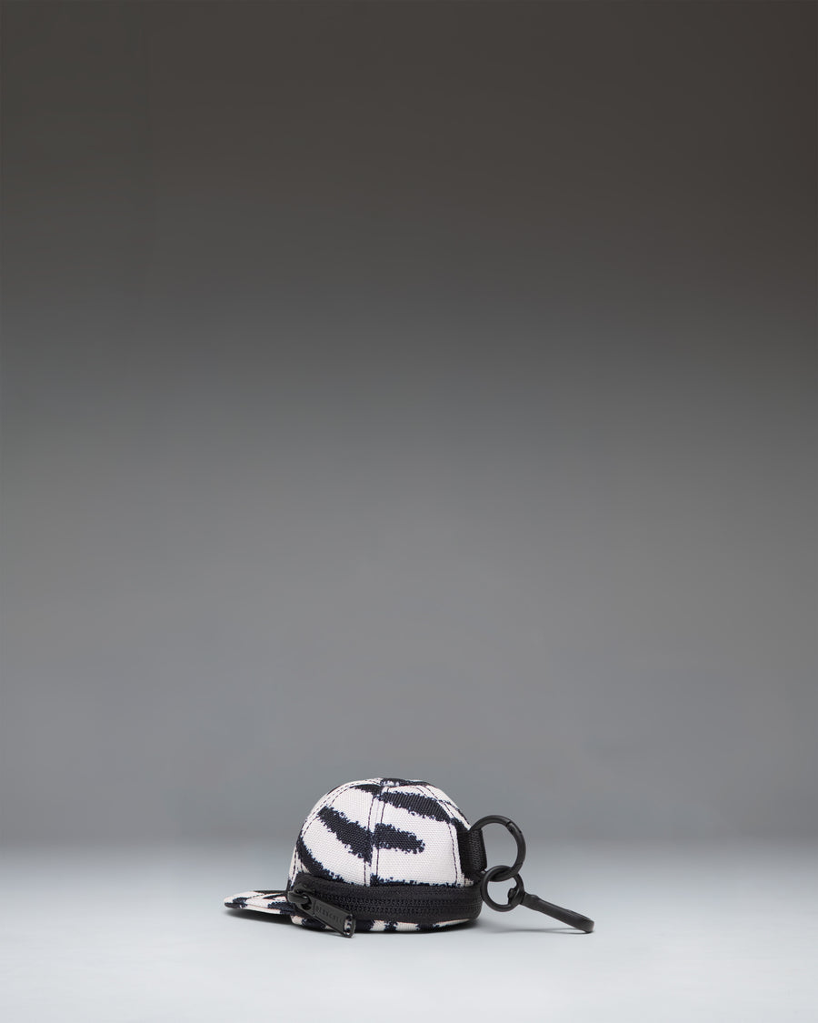 Herschel Supply Co. Sylas Classic Cap Bag Charm in black and white zebra print.