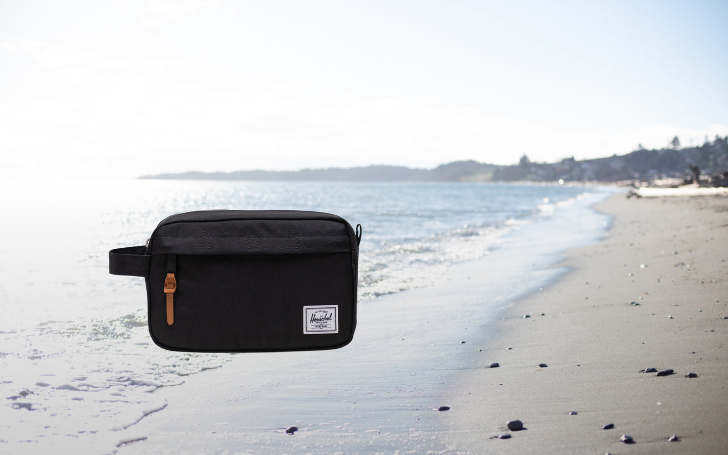 Herschel Supply Co. Chapter Travel Kit in black, a compact toiletry bag featuring a convenient side carrying handle.