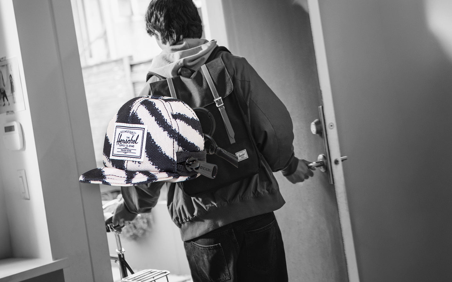 Herschel Supply Co. Sylas Classic Cap Bag Charm in black and white zebra print pattern.